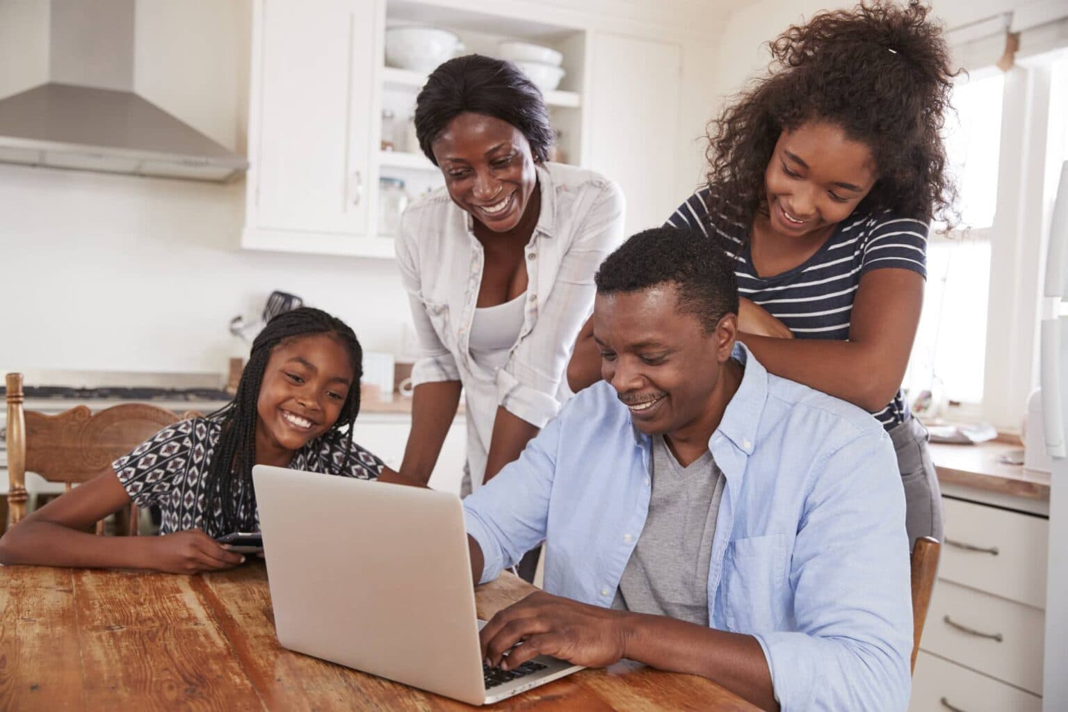 Family reviewing their budget together on a smartphone